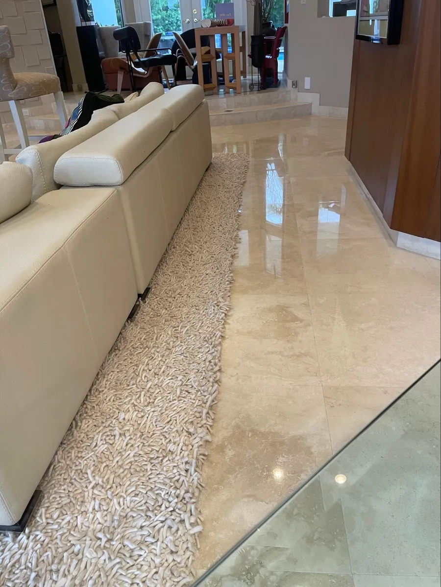 Travertine floor with dull, worn finish before diamond honing and polishing